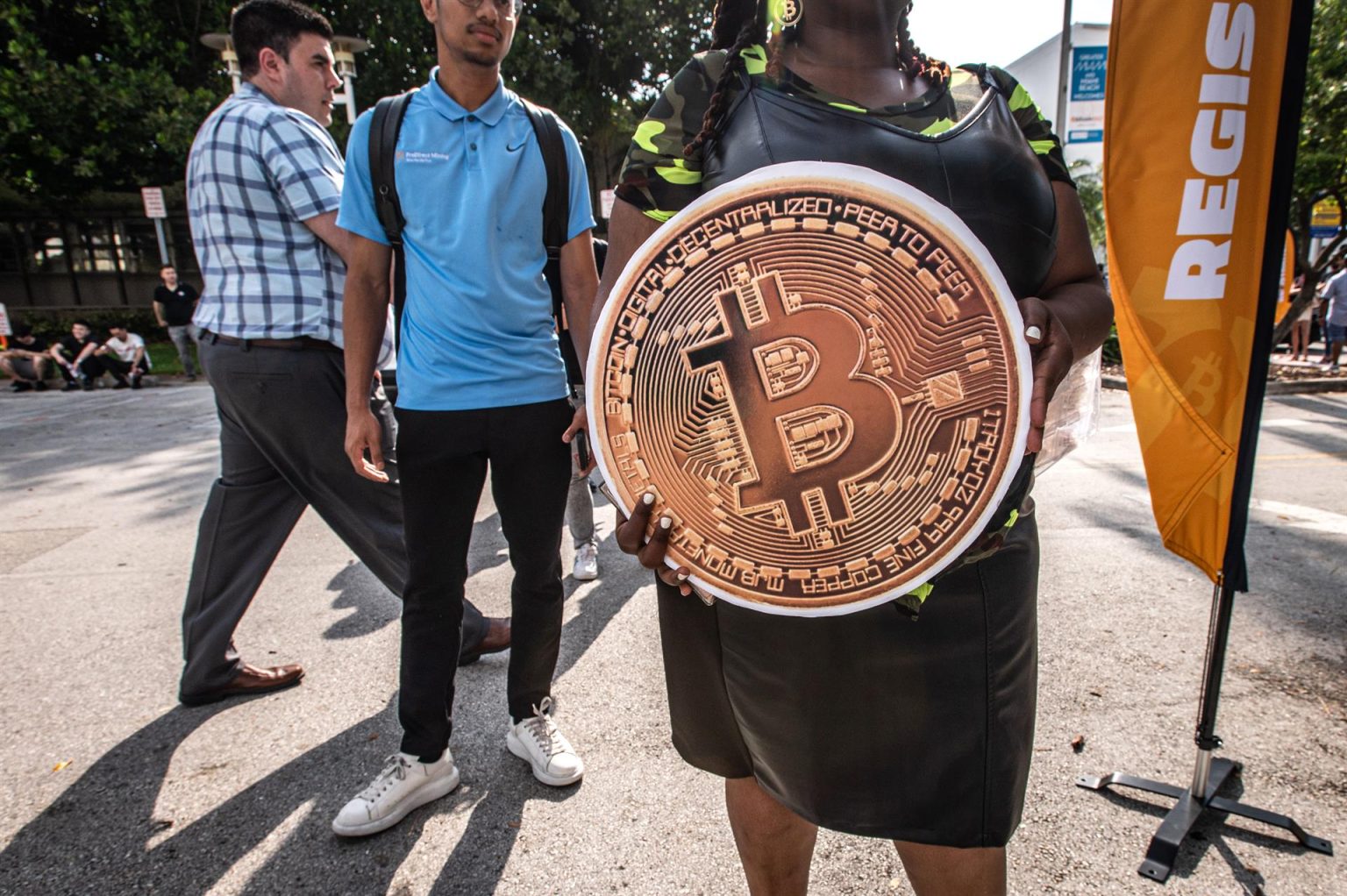 Fotografía de archivo fechada el 6 de abril de 2022 que muestra a una persona sostiene una enorme bitcoin mientras espera en fila para entrar a la conferencia Bitcoin en el Centro de Convenciones de Miami Beach, Florida (EE. UU). EFE/Giorgio Viera