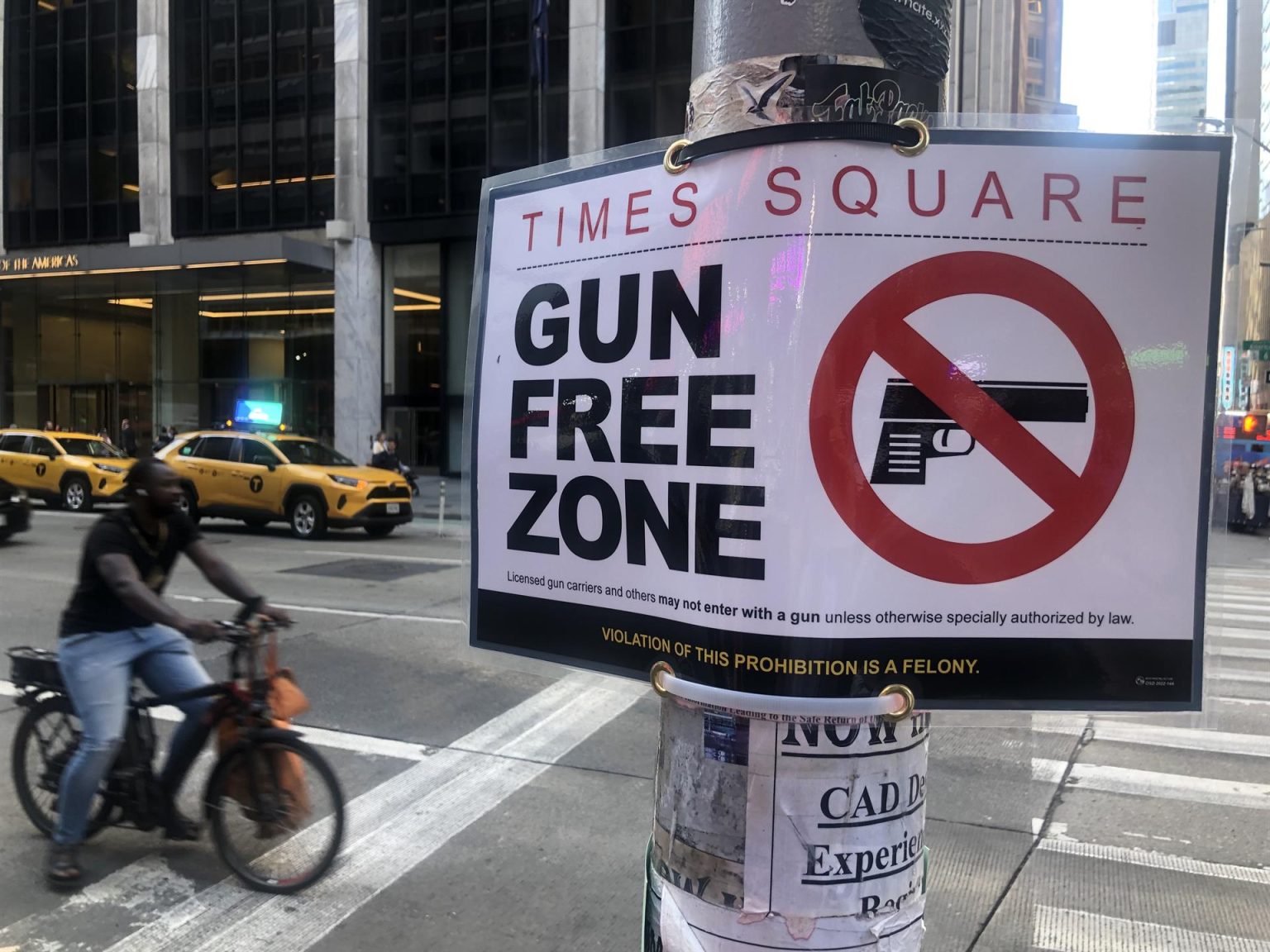 Un taxi pasa delante de un letrero con el mensaje "Times Square, zona libre de armas" hoy miércoles en el centro de Nueva York (EE. UU). EFE/Javier Otazu
