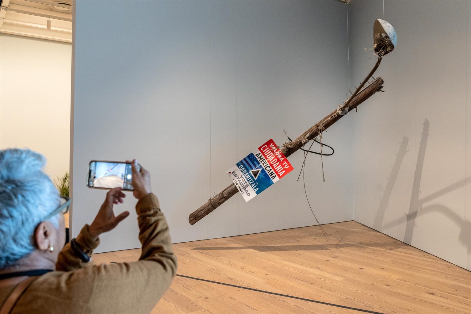 Un hombre toma una foto con su teléfono móvil a la obra de Gabriella Torres-Ferrer titulada "Valora tu mentira americana" (2018) durante un pase especial a la exposición "No existe un mundo poshuracán: Arte puertorriqueño después del huracán María" hoy jueves en el museo Whitney en Nueva York. EFE/Ángel Colmenares