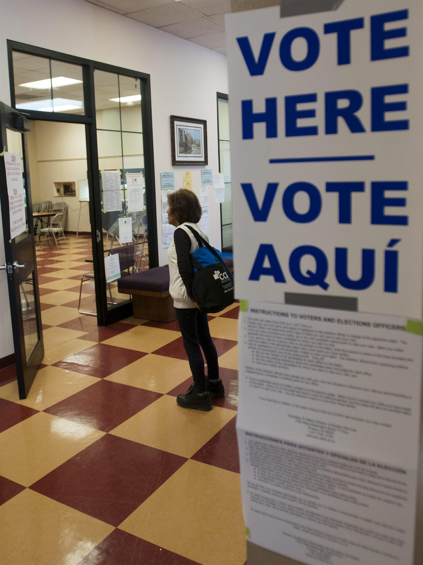 Una mujer hispana lee los carteles de información en un centro de votación del sur de Tucson, Arizona, de mayoría hispana. Imagen de archivo. EFE/Gary Williams