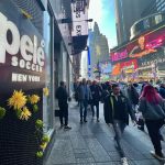 Un hombre pasa delante de unas flores colgadas hoy, en la entrada de la tienda Pelé Soccer situada en la icónica plaza de Times Square, en Nueva York (EEUU). EFE/ Sarah Yáñez-Richards