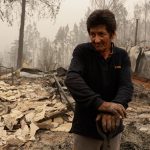 Un hombre se posa sobre escombros y destrozos ocasionados por un incendio hoy, en Santa Juana, Región del Biobío (Chile). EFE/ Esteban Paredes Drake