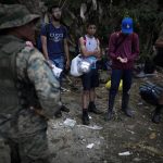 Personas migrantes esperan para ser trasladados en canoa desde la Quebrada León hasta a la comunidad de Bajo Chiquito, el 10 de marzo de 2023, en Darién (Panamá). EFE/ Bienvenido Velasco