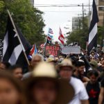 Fotografía de archivo en la que se observa a decenas de personas marchando por el Día Internacional del Trabajador en San Juan (Puerto Rico). EFE/Thais Llorca