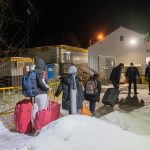 Dos agentes de la policía reciben a un grupo de inmigrantes procedentes de Nueva York en la frontera de Roxham Roada que separa EE.UU. de Canadá en Plattsburgh, Nueva York. EFE/Ángel Colmenares