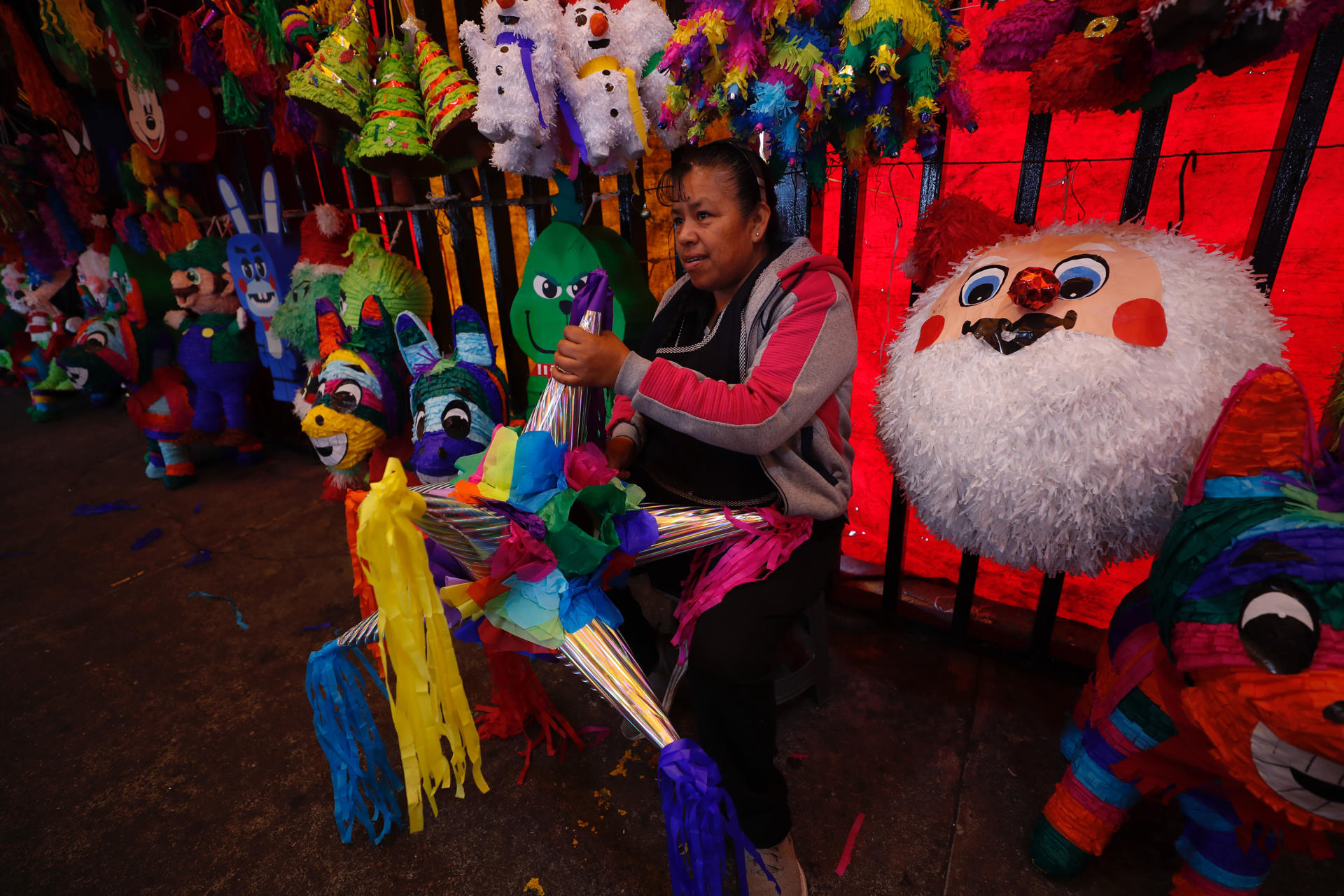 Una vendedora sostiene una piñata en el mercado de Jamaica, el 15 de diciembre de 2023, en Ciudad de México (México). EFE/ Sáshenka Gutiérrez
