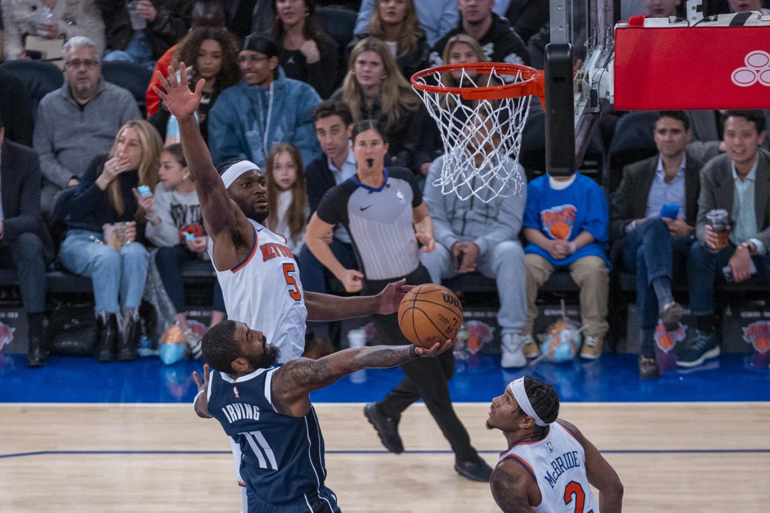 Kyrie Irving (abajo) jugador de Dallas Mavericks salta a canasta sobre la marca de Precious Achiuwa de los Knicks durante un juego de la NBA entre New York Knicks y Dallas Mavericks en el Madison Square Garden de Manhattan New York (EE.UU.). EFE/Ángel Colmenares