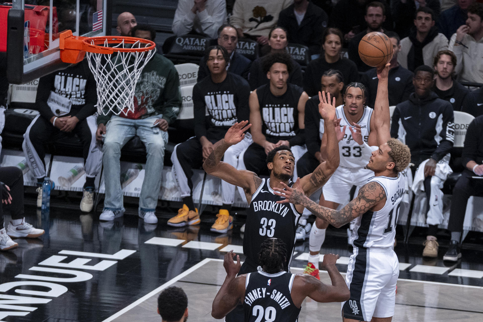 Jeremy Sochan (d) de San Antonio Spurs salta a canasta sobre la marca de Nic Claxton (c) de Brooklyn Nets hoy, durante un partido de NBA disputado en el Barclays Center en Brooklyn, Nueva York (EE.UU.). EFE/ Ángel Colmenares
