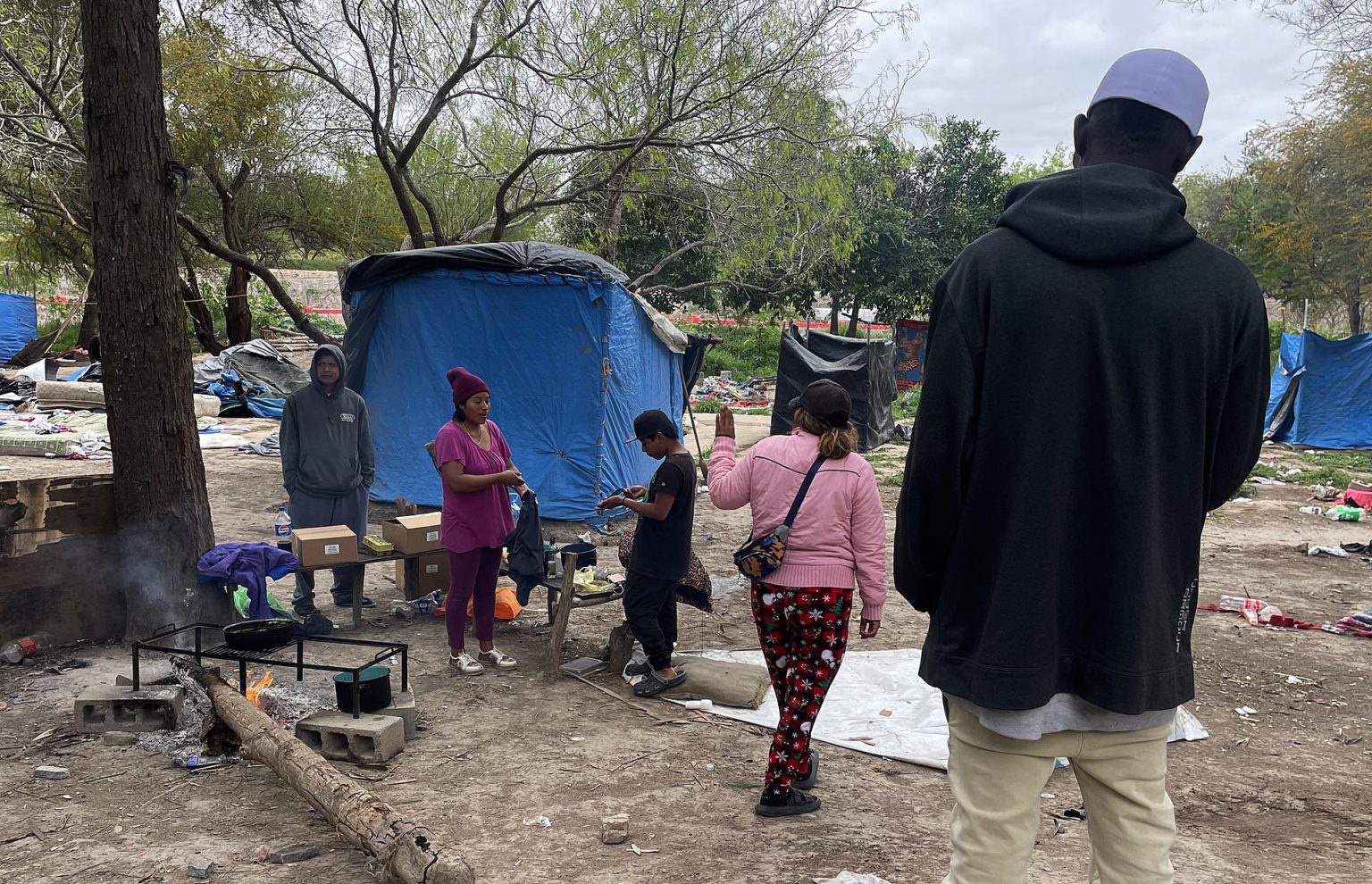 Migrantes permanecen en un campamento improvisado junto al río Bravo en la frontera que divide a México de los Estados Unidos, este jueves en la ciudad de Matamoros, estado de Tamaulipas (México). EFE/Abraham Pineda Jácome