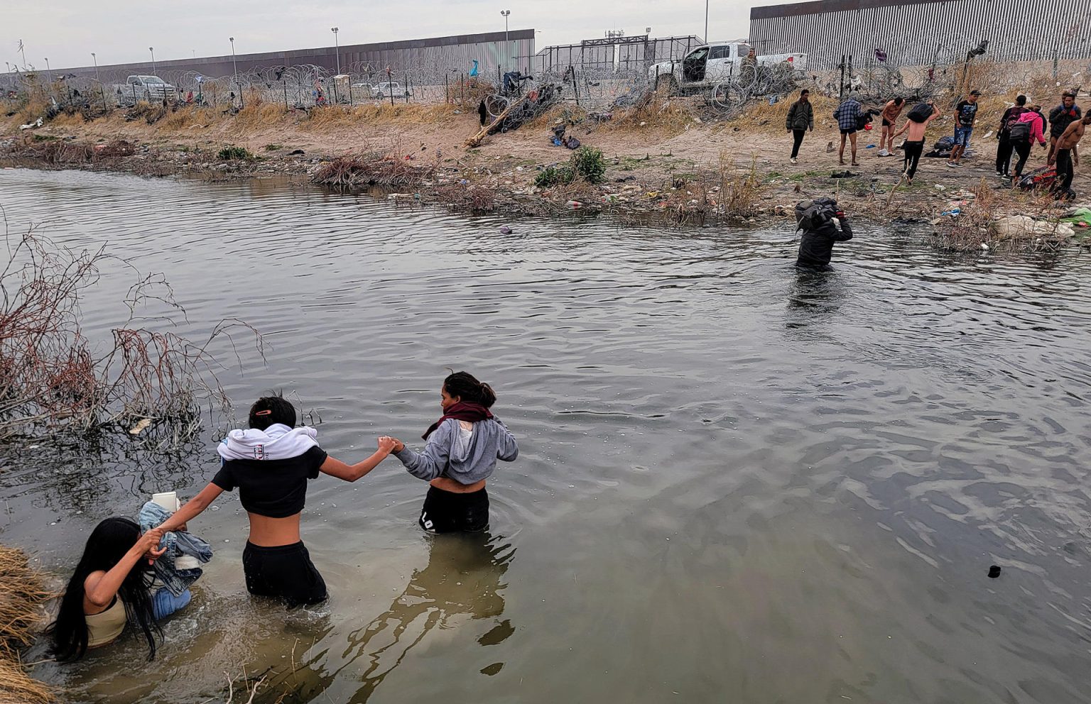 Migrantes se preparan para cruzar el Río Bravo, en la frontera que divide a México de los Estados Unidos, este jueves en Ciudad Juárez (México). EFE/Luis Torres