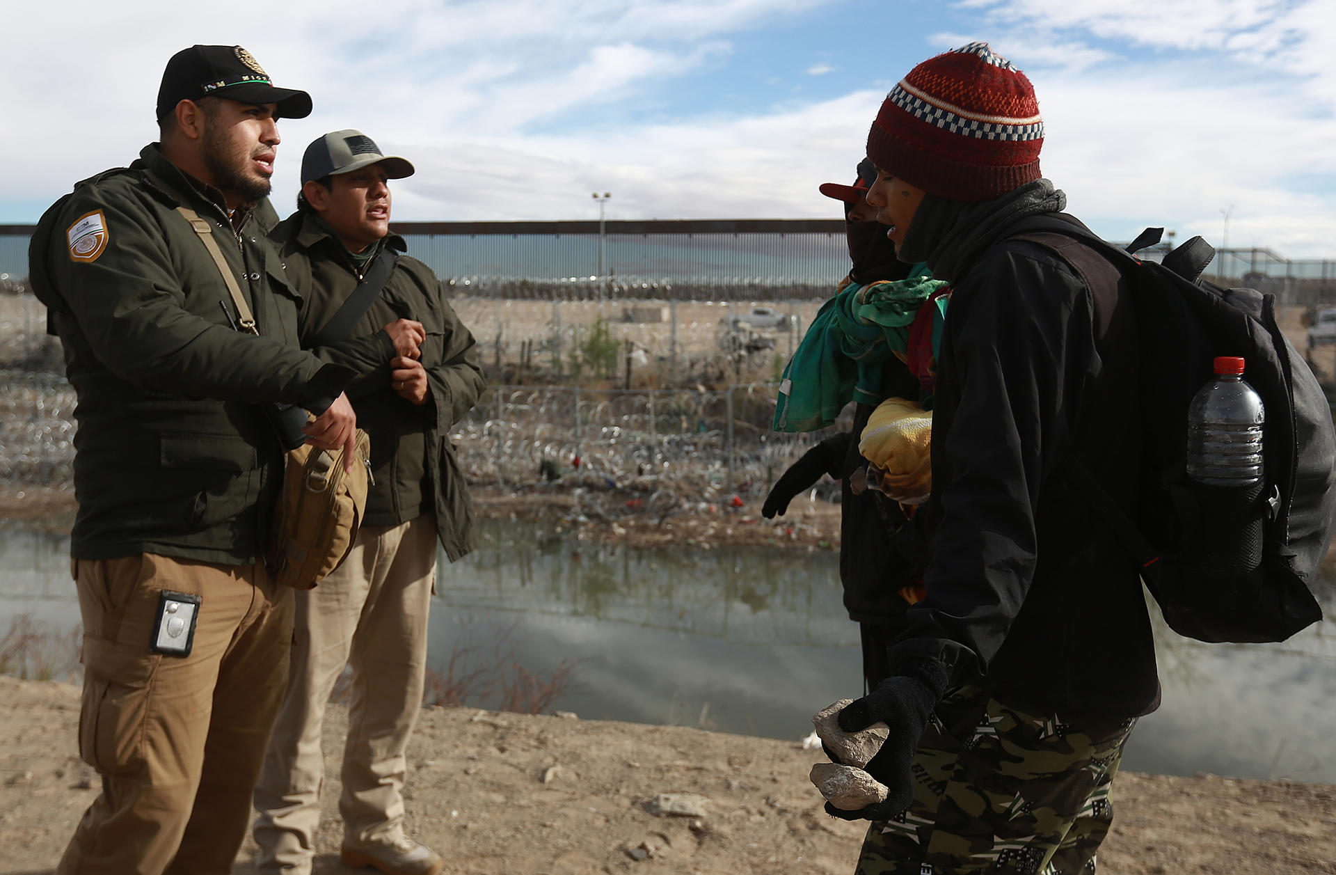 Personal del Instituto Nacional de Migración (INM) y un grupo de migrantes dialogan tras una trifulca este martes, en las inmediaciones de la frontera con Estados Unidos, en Ciudad Juárez (México). EFE/Luis Torres
