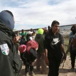 Personal del Instituto Nacional de Migración (INM) y un grupo de migrantes dialogan tras una trifulca este martes, en las inmediaciones de la frontera con Estados Unidos, en Ciudad Juárez (México). EFE/Luis Torres