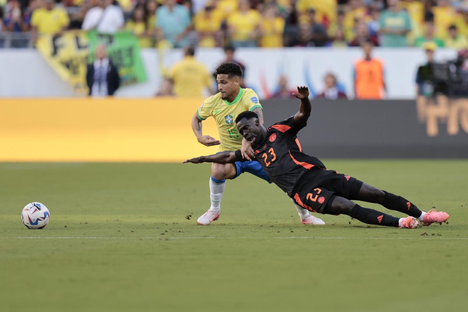 El defensa central colombiano Davinson Sánchez (d) fue registrado este martes, 2 de julio, al caer ante la marca del centrocampista brasileño Joao Gomes (c), durante el partido de cierre del grupo D de la Copa América 2024, en el Levi´s Stadium de Santa Clara (California, EE.UU.). EFE/John G.Mabanglo