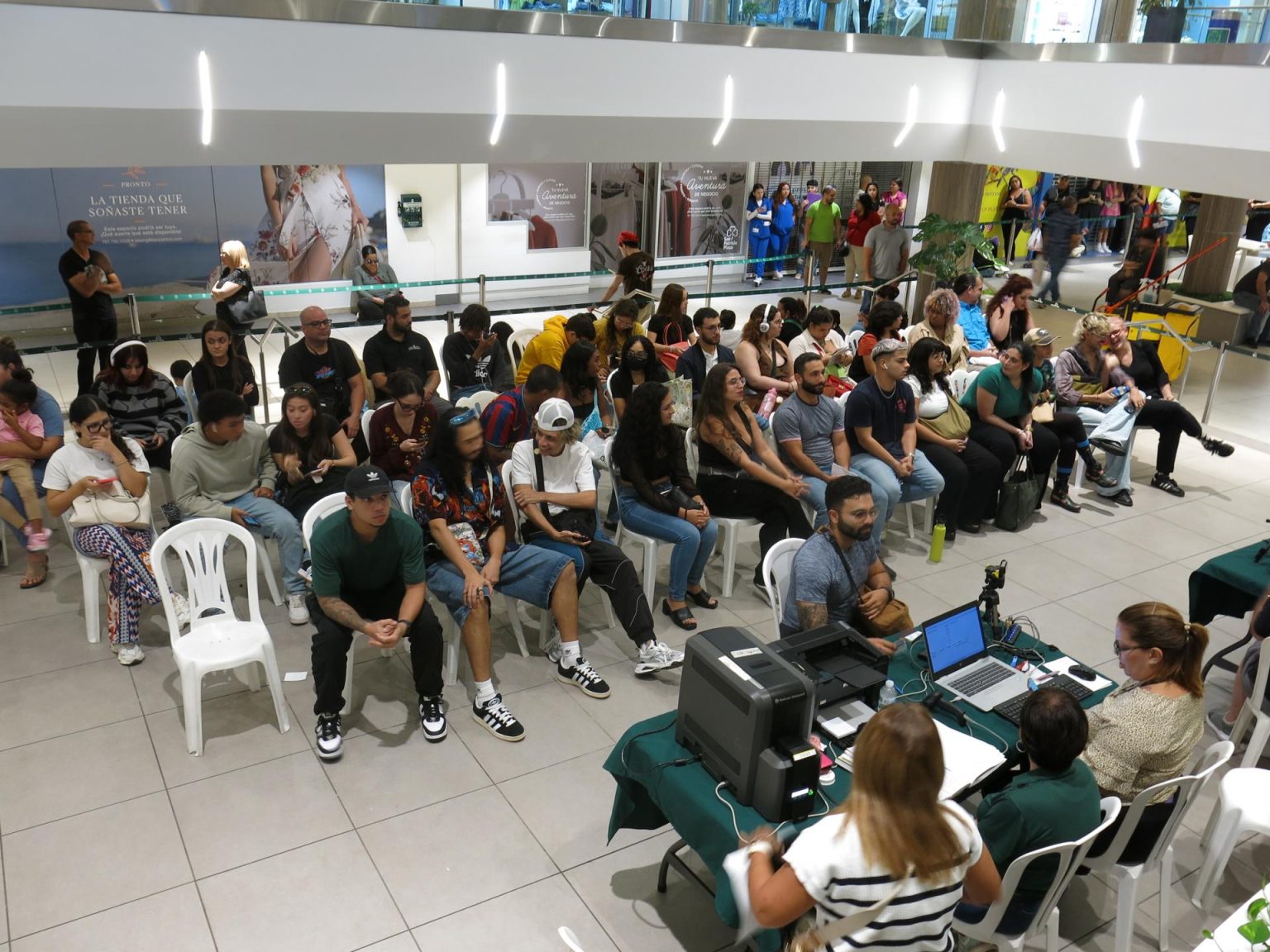 Decenas de personas esperan en una sala para inscribirse en el registro de votantes, en el centro de inscripción habilitado en por un día en el Centro Comercial de San Patricio en San Juan, Puerto Rico. EFE/Esther Alaejos