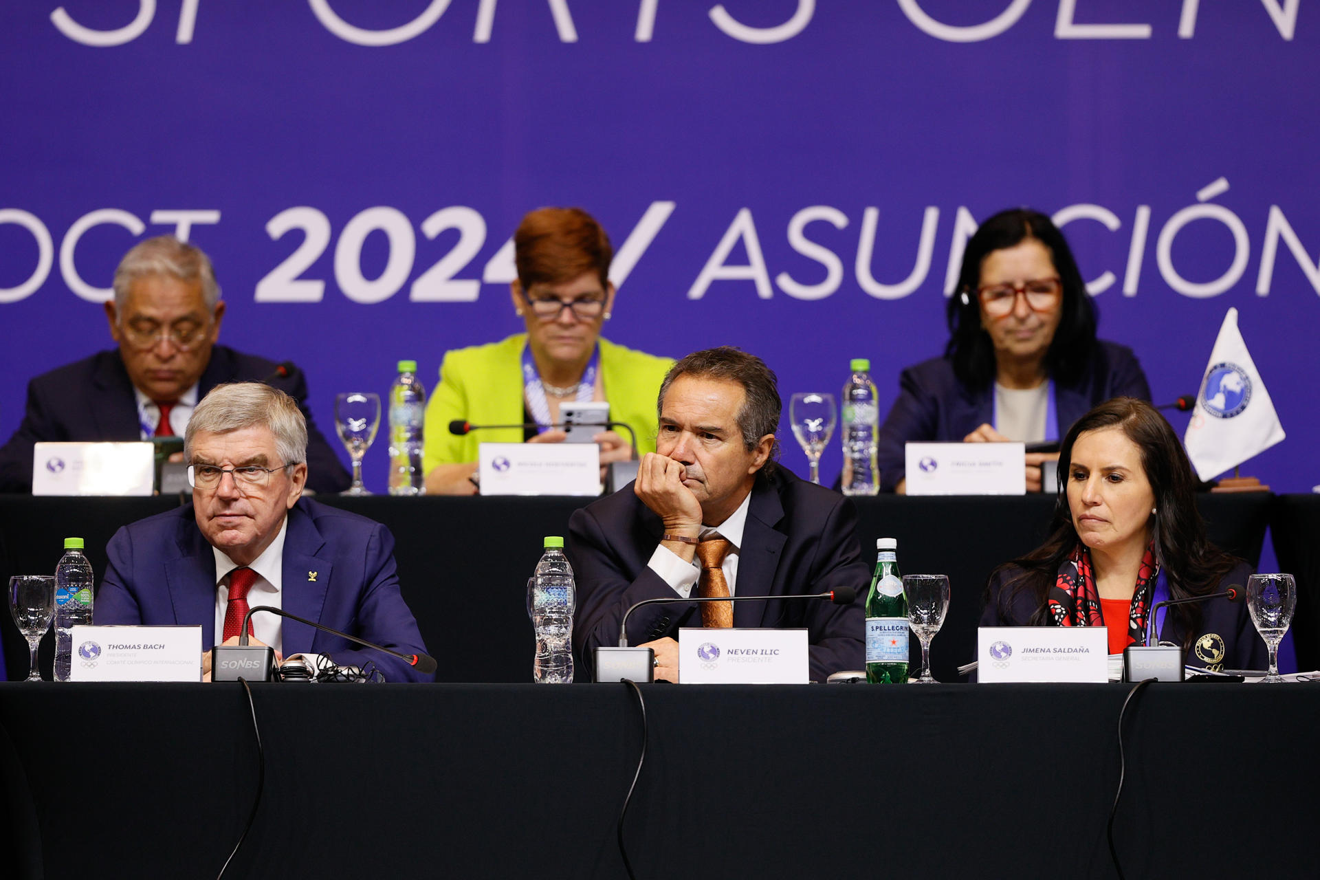 El presidente del Comité Olímpico Internacional (COI), Thomas Bach (i); el presidente de Panam Sports, Neven Ilic (c); y la secretaria general de Panam Sports, Jimena Saldaña, participan este miércoles en los debates de la Asamblea General Panam Sports en la ciudad paraguaya de Luque. EFE/ Juan Pablo Pino
