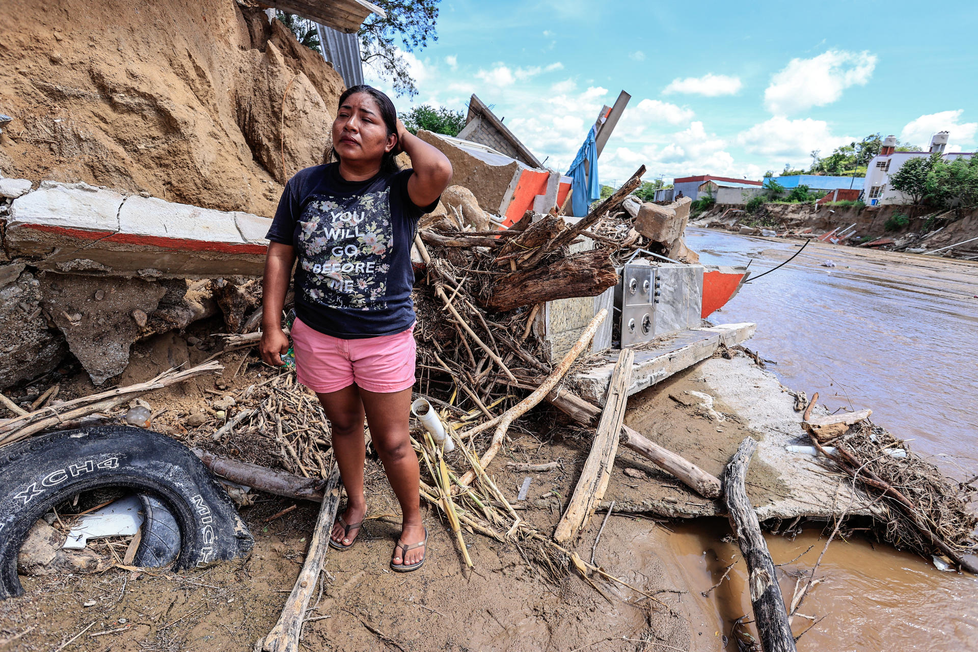 Verónica López Galindo posa frente a los escombros de su casa, destruida por la creciente del río de San Agustín tras el paso del huracán John, este viernes en Acapulco (México). EFE/David Guzmán
