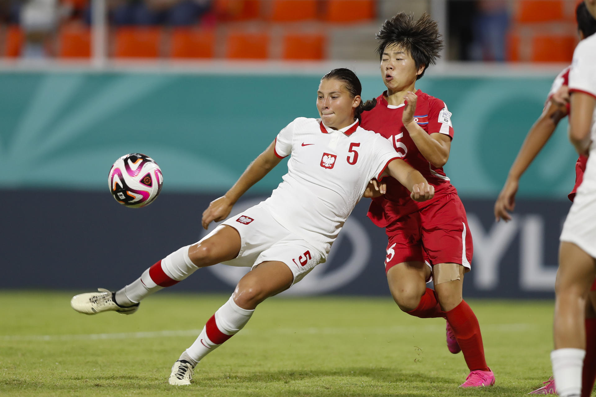 Choe Il-son, de Corea del Norte, marca a la polaca Emilia Sobierajska en partido de los cuartos de final del Mundial sub-17 en Santiago de los Caballeros (República Dominicana). EFE/ Diana Sánchez
