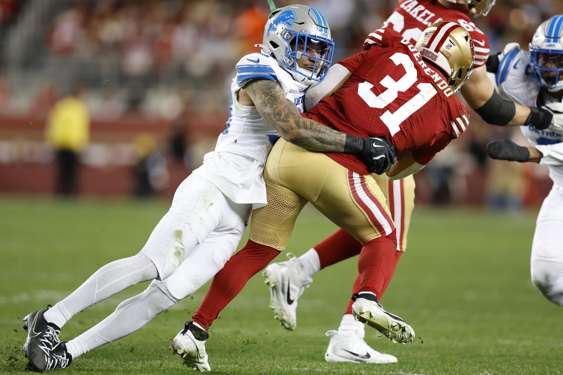 El 'safety' de Detroit Lions, Brian Branch (i), taclea al corredor de San Francisco 49ers, Isaac Guerendo (d), durante el partido de la penúltima semana de la NFL jugado este lunes en Santa Clara (California) EFE/EPA/JOHN G. MABANGLO
