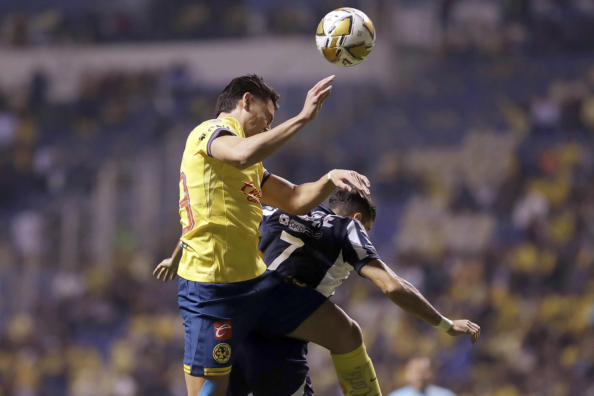 Alan Cervantes (i) de América disputa el balón con German Berterame de Monterrey, este jueves durante el partido de ida de la final del torneo Apertura mexicano jugado en Puebla. EFE/ Hilda Ríos
