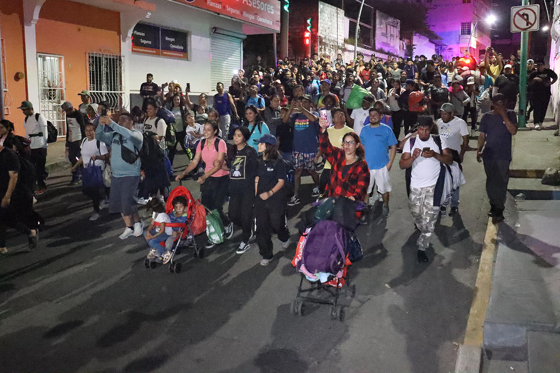 Migrantes caminan en caravana la madrugada de este domingo en el municipio de Tapachula, en el estado de Chiapas (México). EFE/Juan Manuel Blanco
