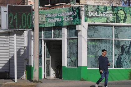 Una persona camina frente a una casa de cambio este lunes, en Ciudad Juárez, en Chihuahua (México). EFE/ Luis Torres