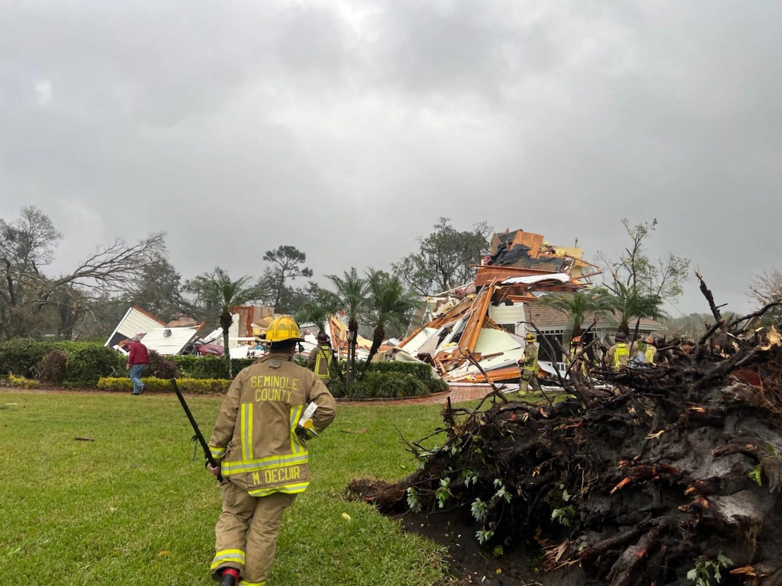 Fotografía cedida por el Departamento de Bomberos del Condado Seminole donde aparece uno de sus agentes mientras observa a una casa destrozada este lunes en Longwood, Florida. EFE/Bomberos del Condado Seminole /SOLO USO EDITORIAL /NO VENTAS /SOLO DISPONIBLE PARA ILUSTRAR LA NOTICIA QUE ACOMPAÑA /CRÉDITO OBLIGATORIO