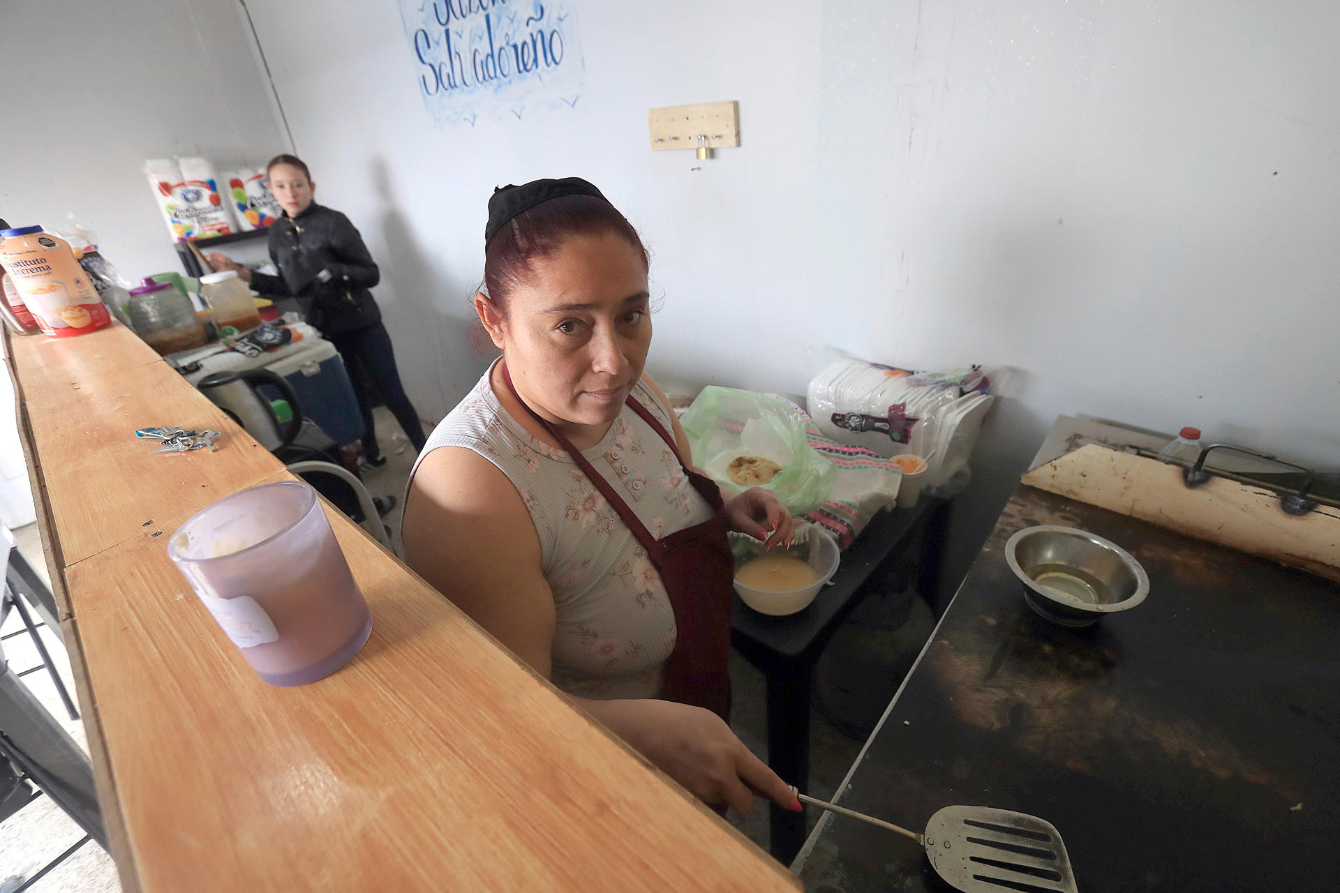 Karla García, migrante de origen salvadoreña atiende un negocio de comida este martes en Ciudad Juárez (México). EFE/ Luis Torres
