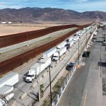 Fotografía aérea donde se observa una fila de vehículos de carga para cruzar una garita hacia EEUU, este miércoles en la ciudad de Tijuana (México). EFE/ Joebeth Terriquez